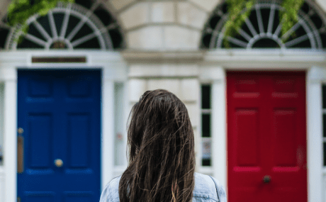 woman facing two doors